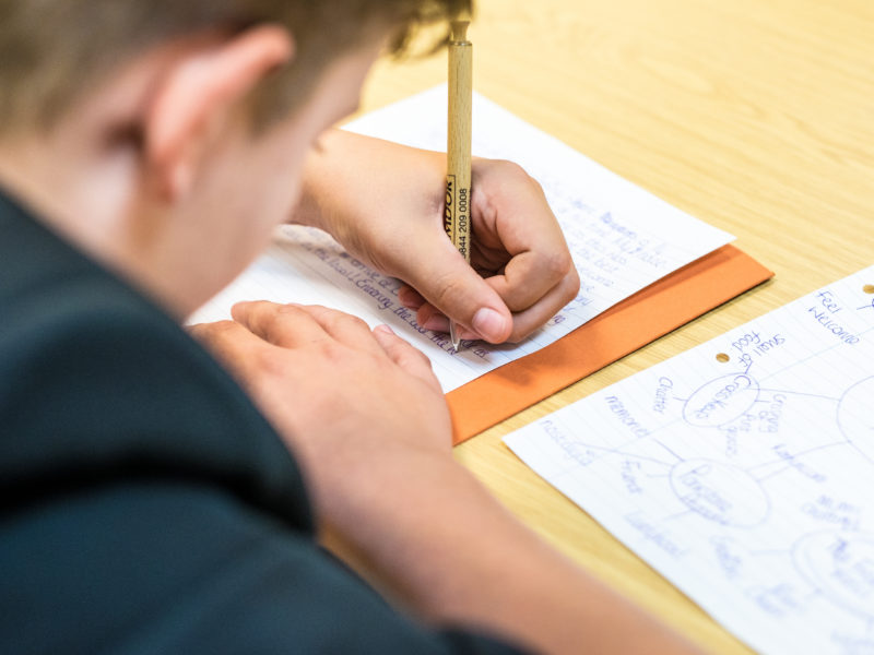 Student writing at YWF